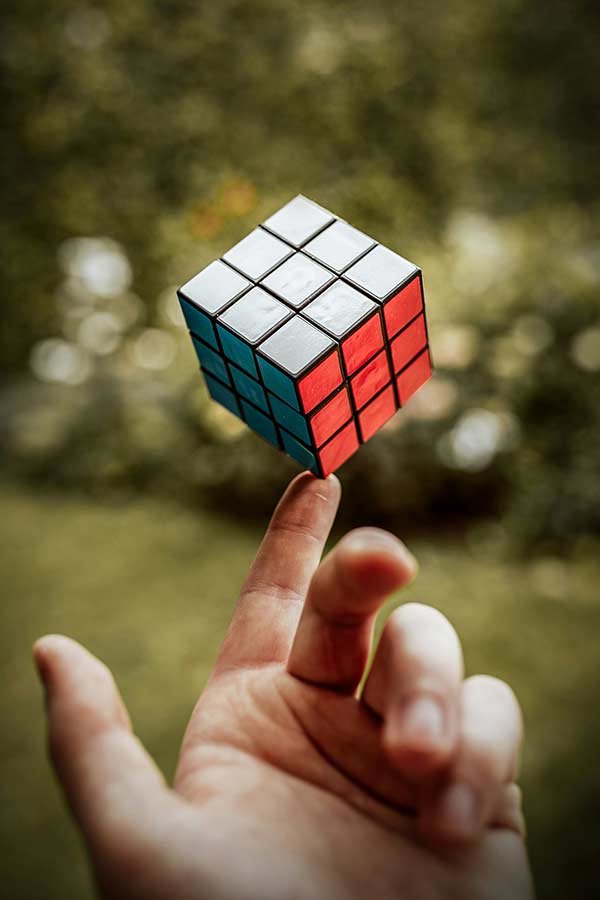 Hand balancing a Rubik's Cube on one finger