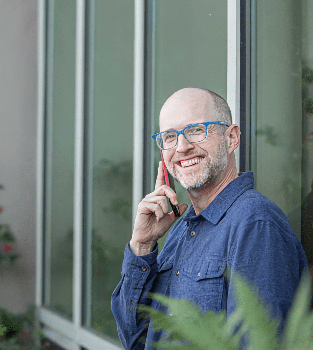 Greg Goodman, founder of Goodman Creatives, smiling while talking on the phone