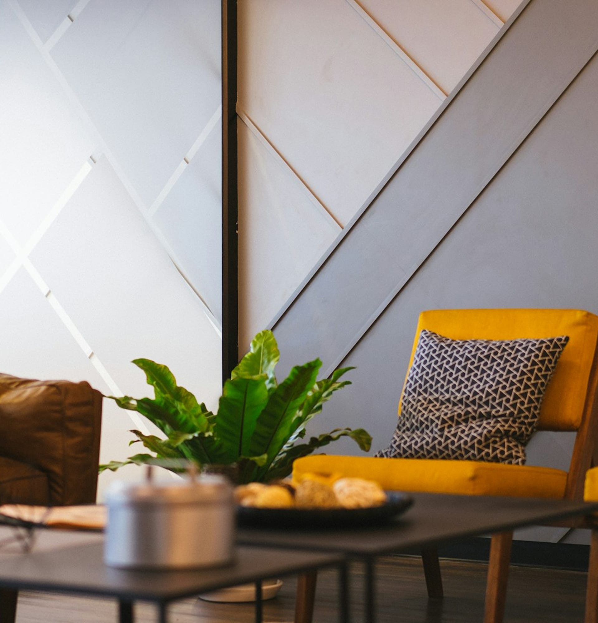 Therapy office with a yellow armchair and a potted plant